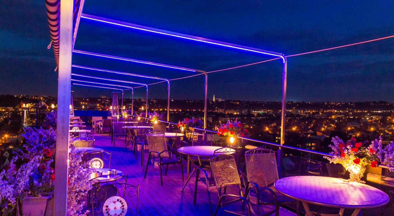 The essence of exceptional living a group of tables and chairs with lights on them
