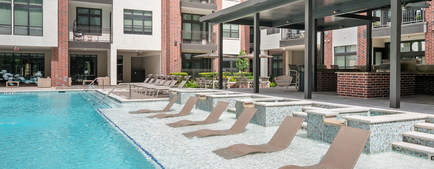 a pool with seating on a water shelf