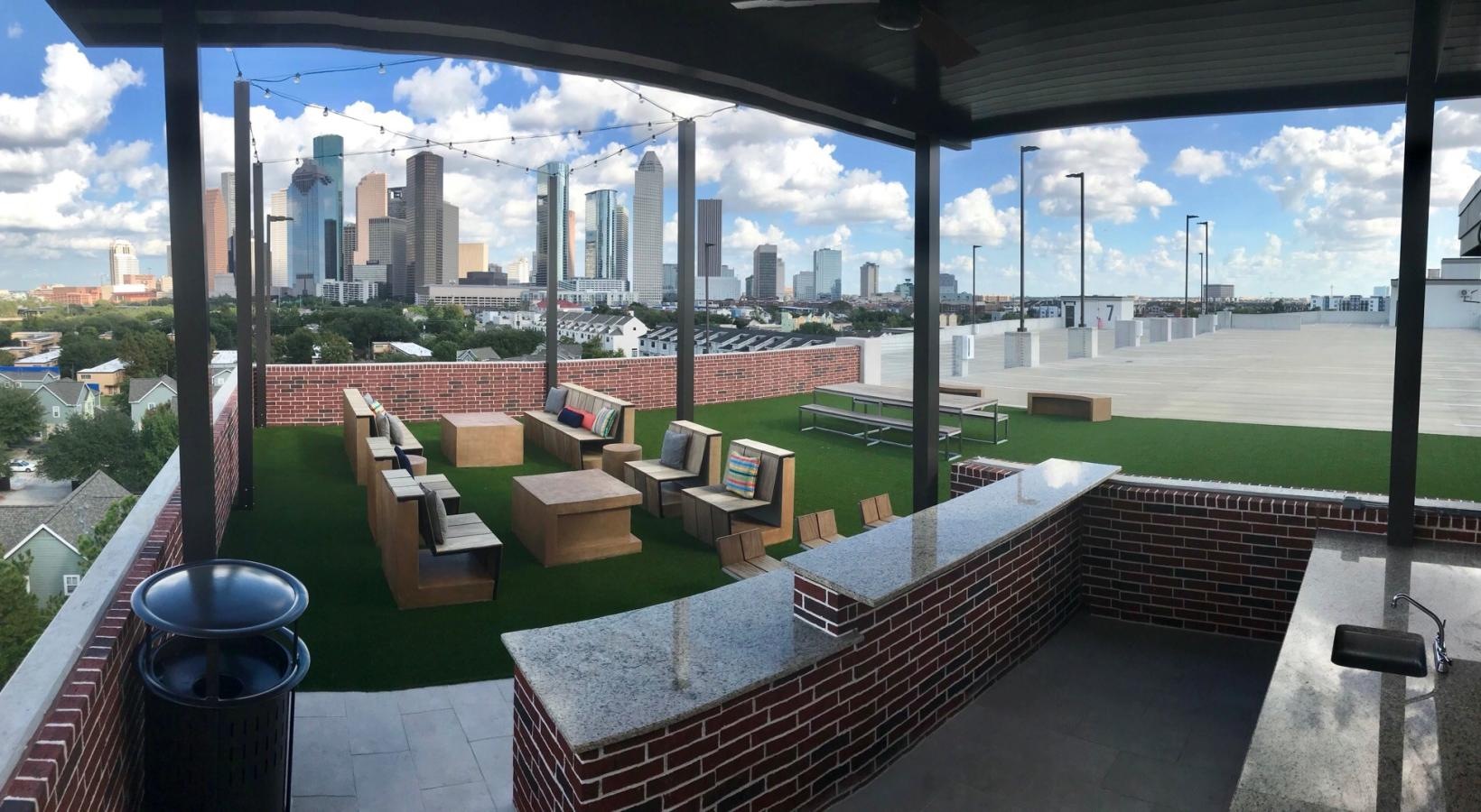 Settle into comfort at Tinsley on the Park a patio with chairs and a view of a city