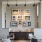 a room with a table chairs and a window with art on the wall