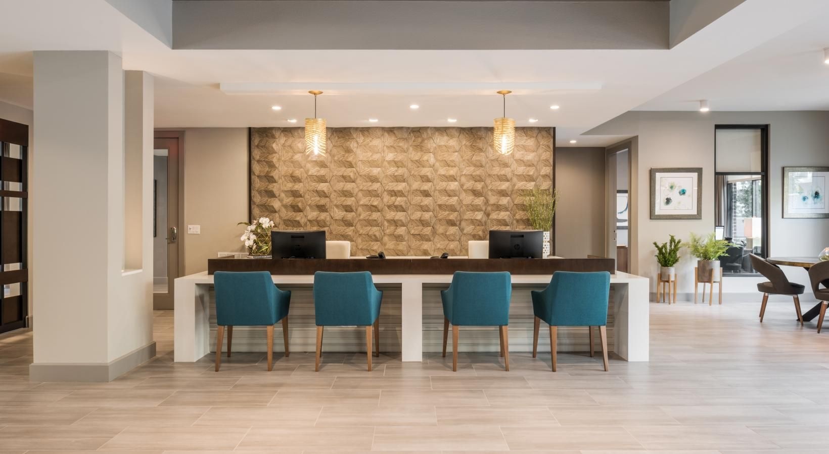 Everything within reach a large kitchen with a bar and chairs