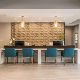 Everything within reach a large kitchen with a bar and chairs