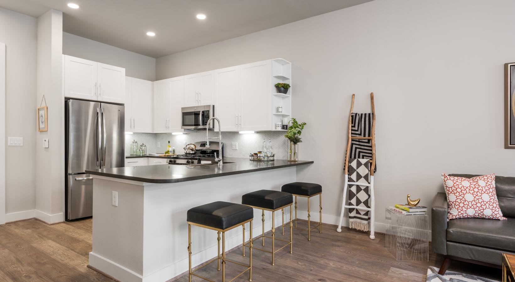 Relax and unwind in stylish living spaces a kitchen with stools and a bar stool