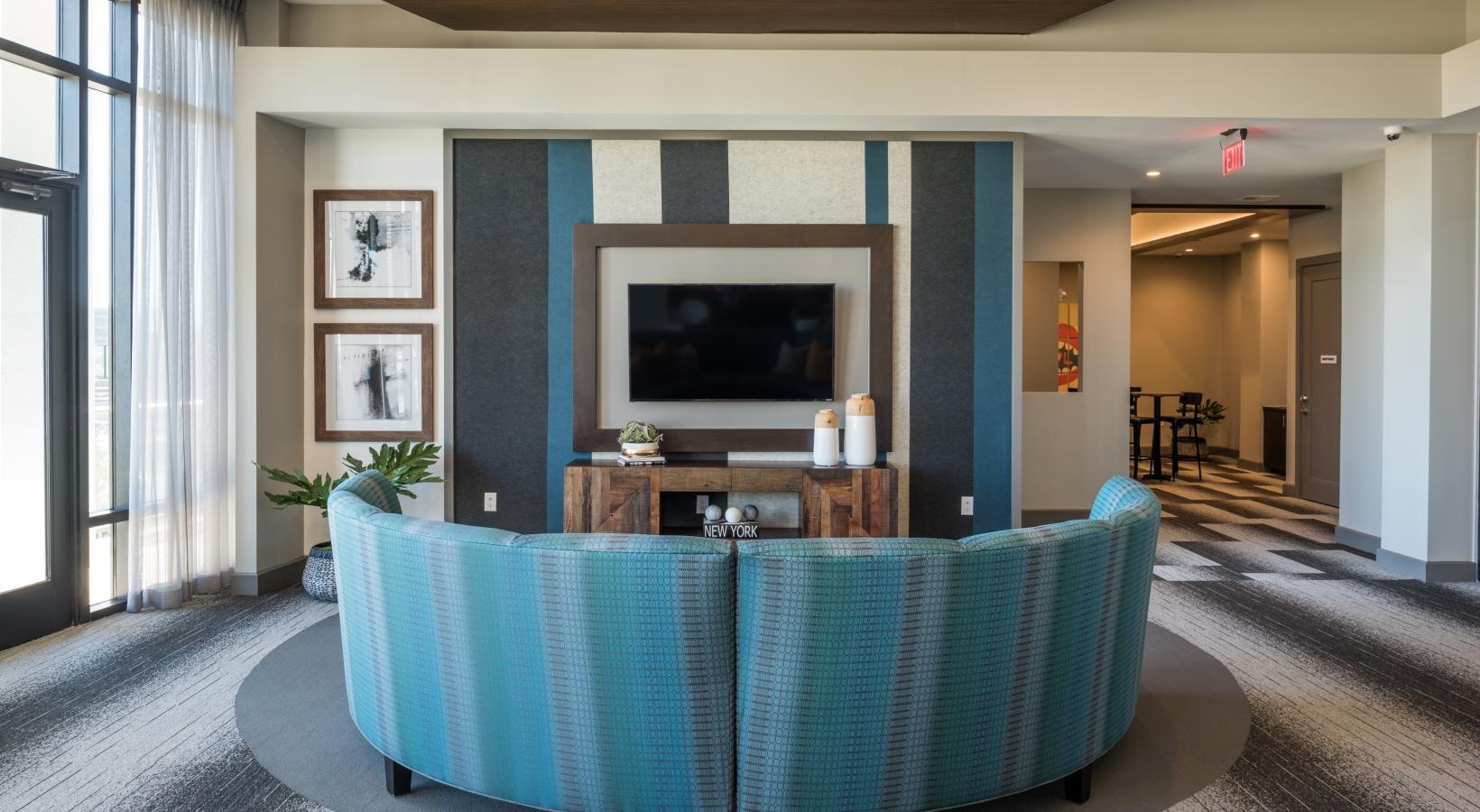 Settle into comfort at Tinsley on the Park a room with a tv and a table