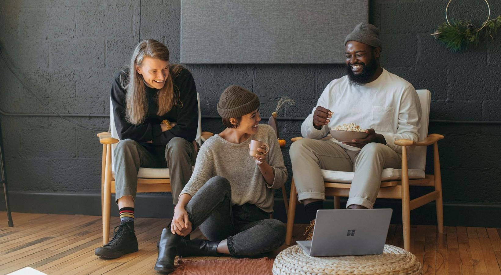 Refined spaces to match your style friends sit together around an open laptop