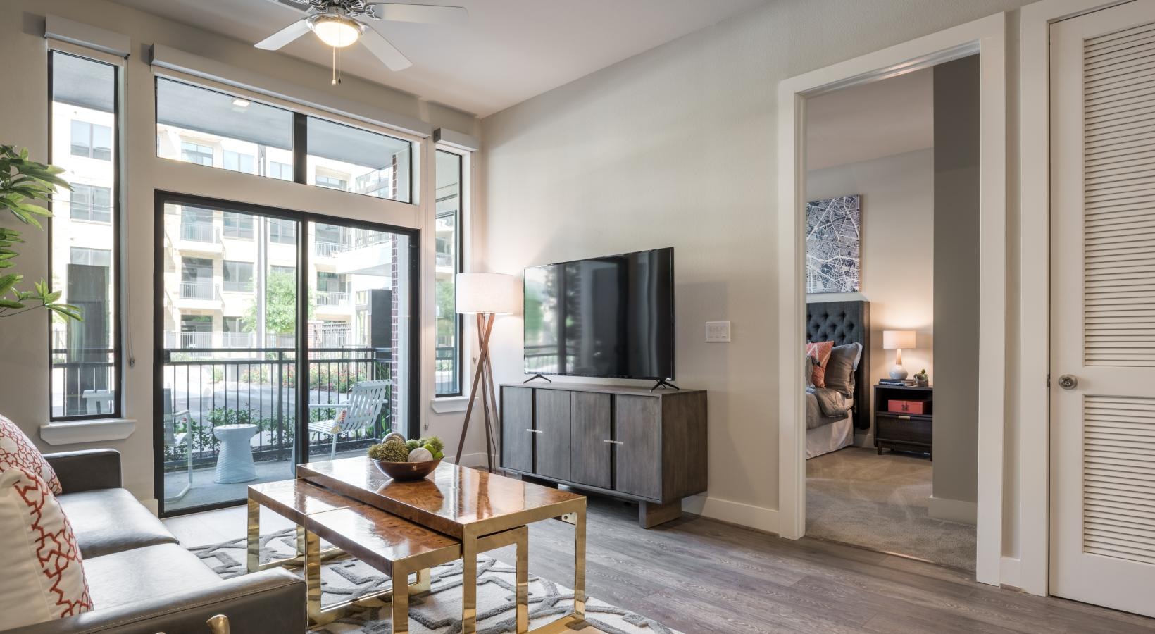 Relax and unwind in well-lit living areas a living room with a tv and a table