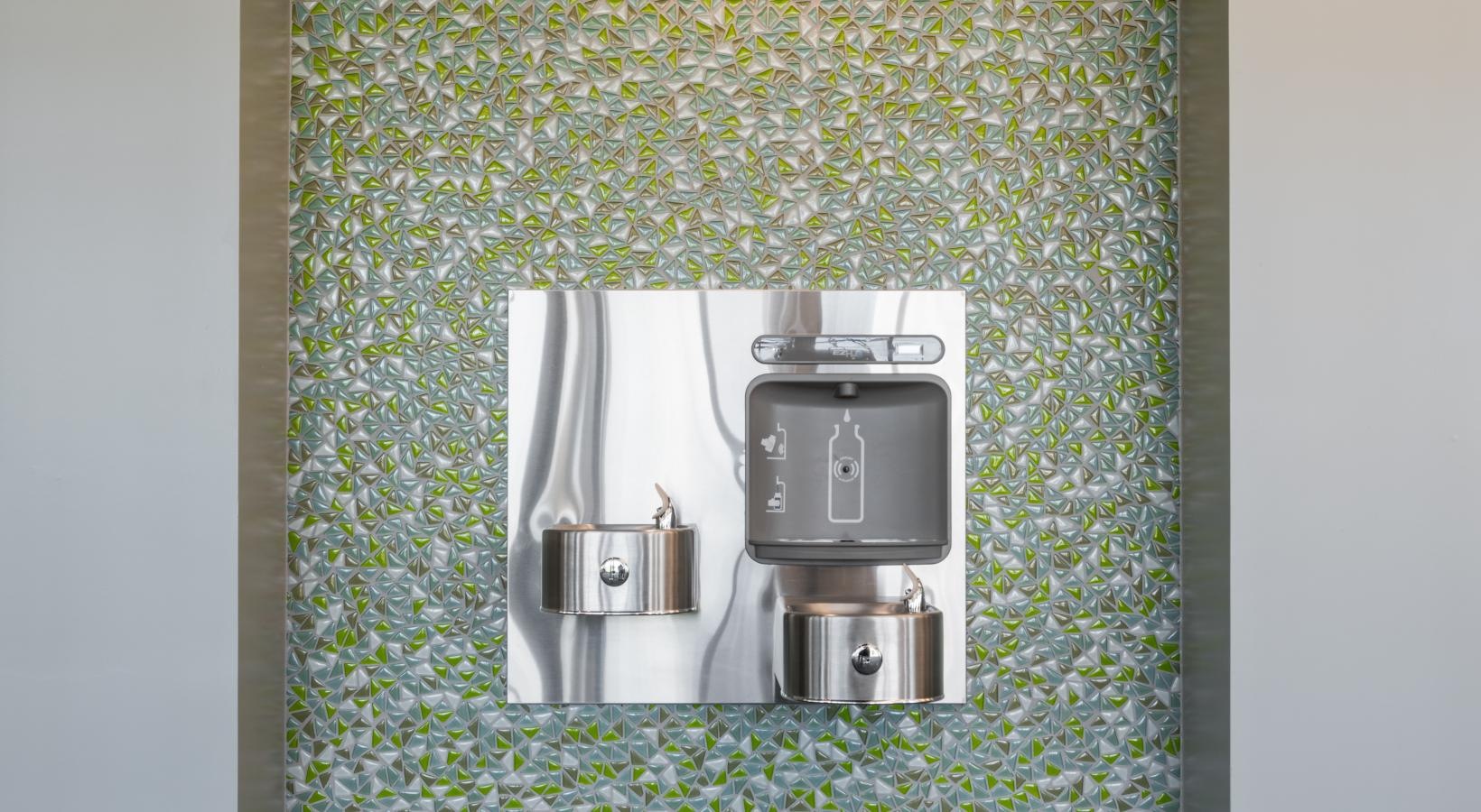 Settle into comfort at Tinsley on the Park a wall with a mirror and a rug