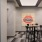 a room with a table chairs and a painting on the wall
