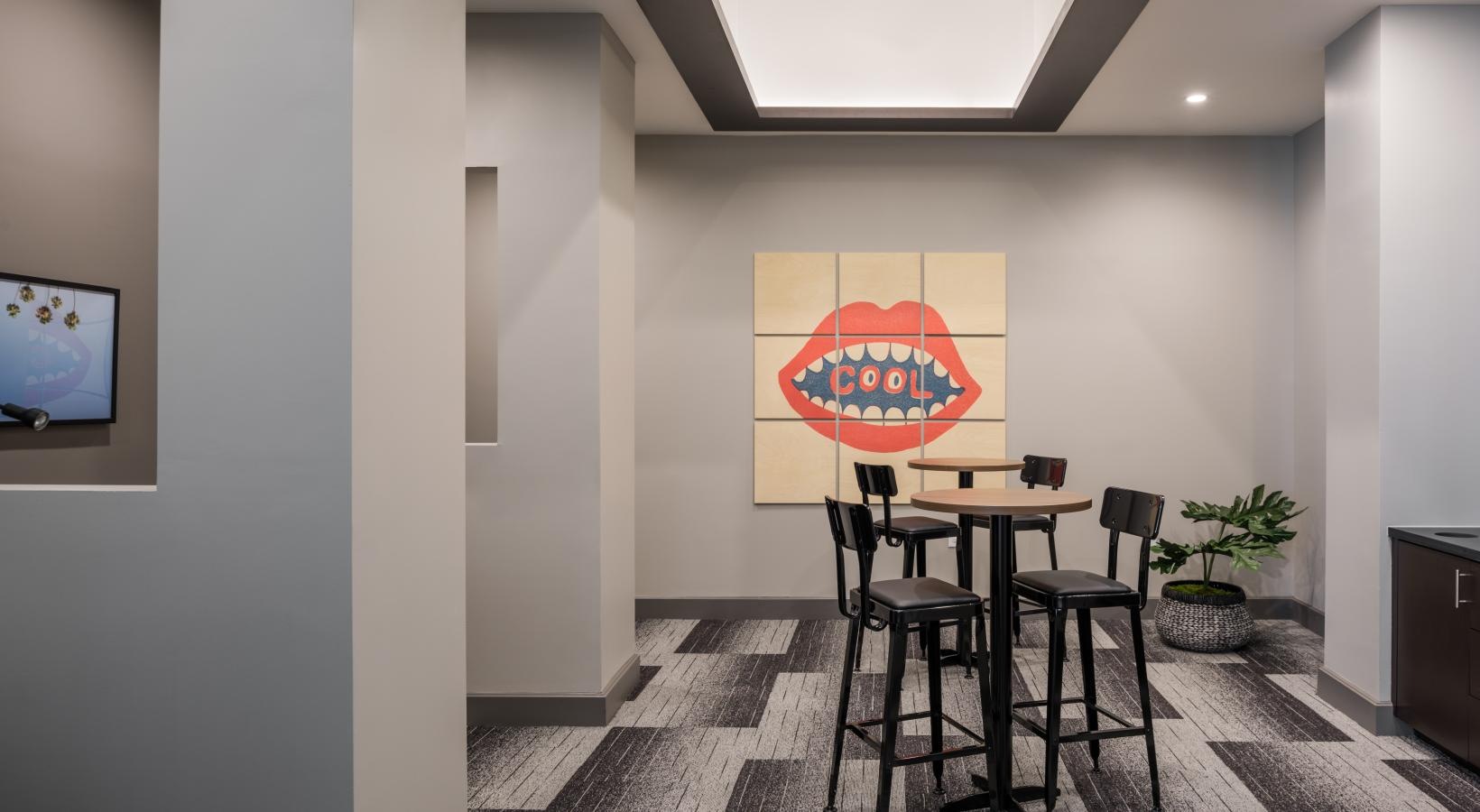 Find your perfect fit at Tinsley on the Park a room with a table chairs and a painting on the wall