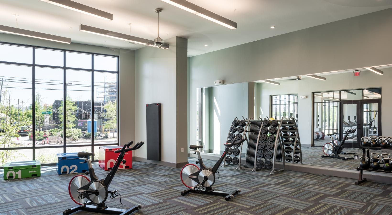 Quick access to state-of-the-art amenities a room with exercise equipment
