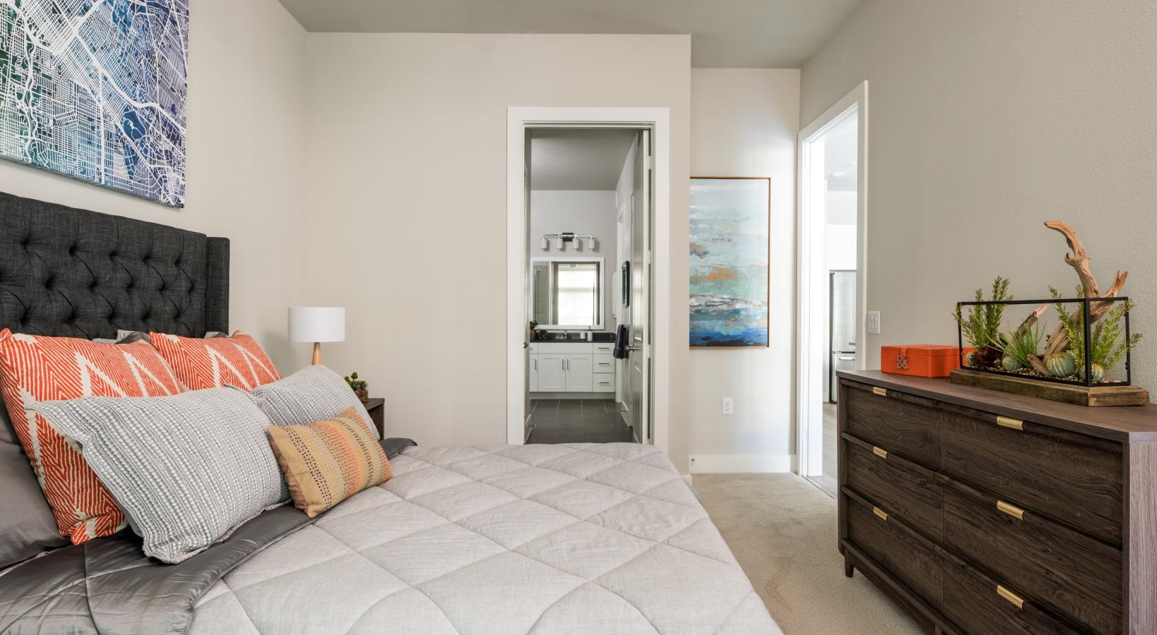 Relax and recharge in beautiful and spacious bedrooms a bedroom with a bed and a dresser